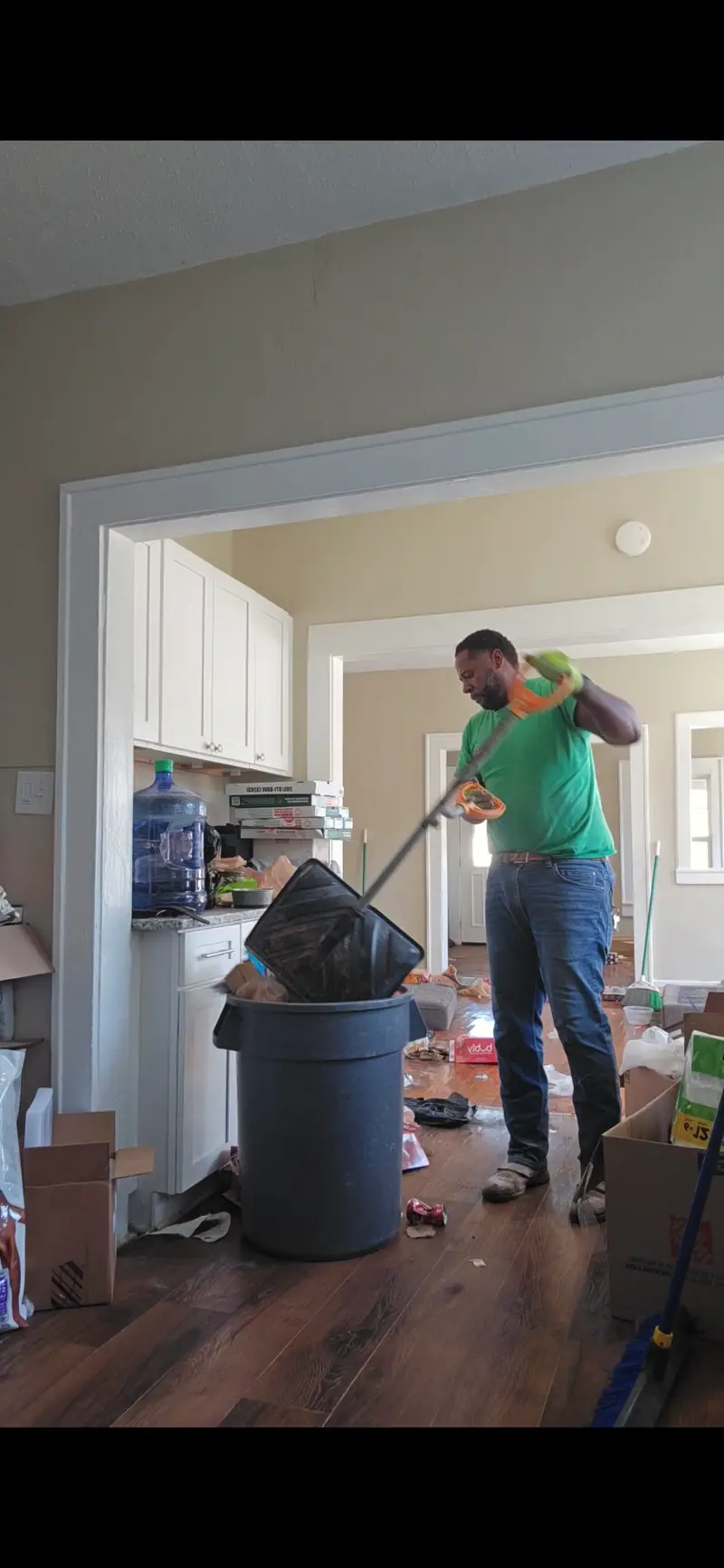 A Racoons crew member clearing trash during a cleanout