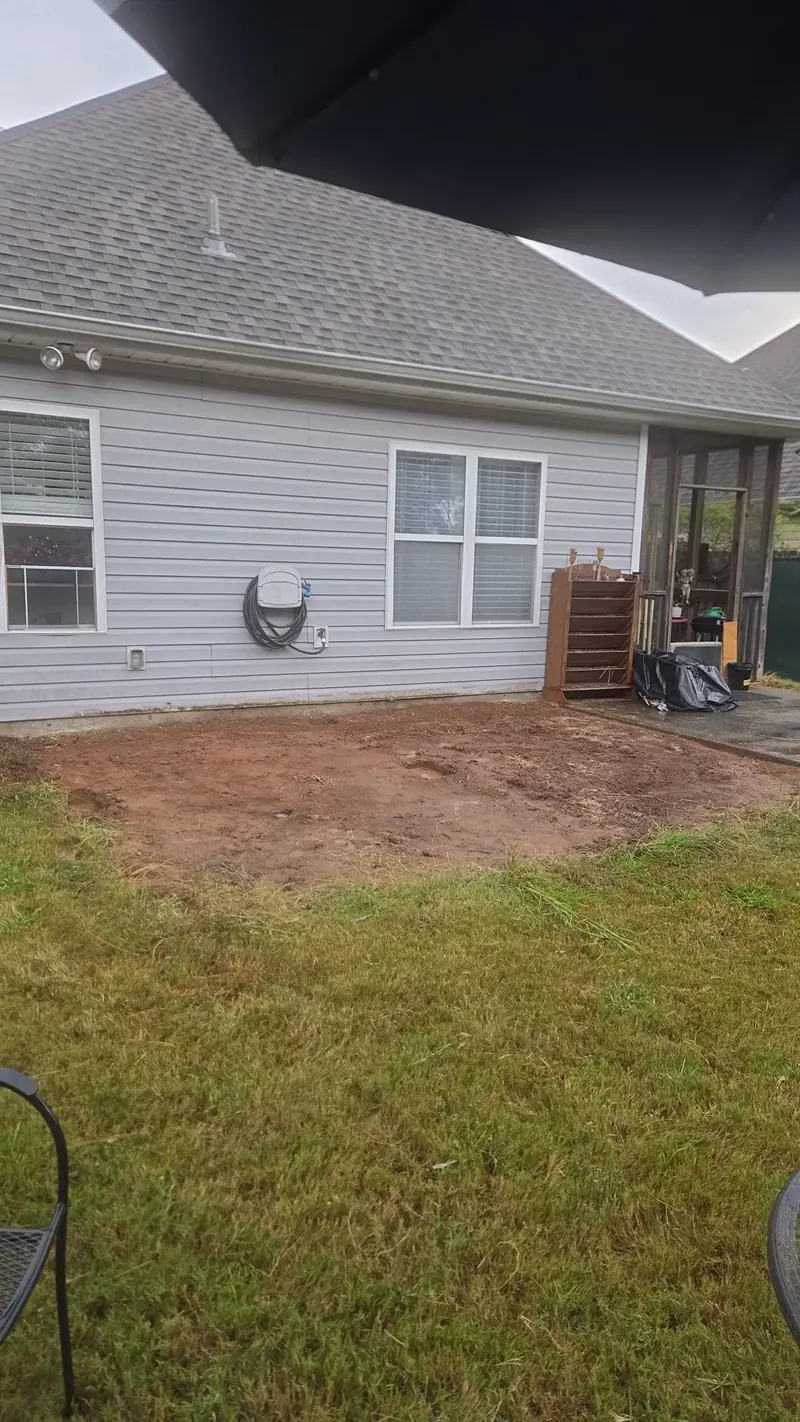 The bare ground where the deck stood after removal