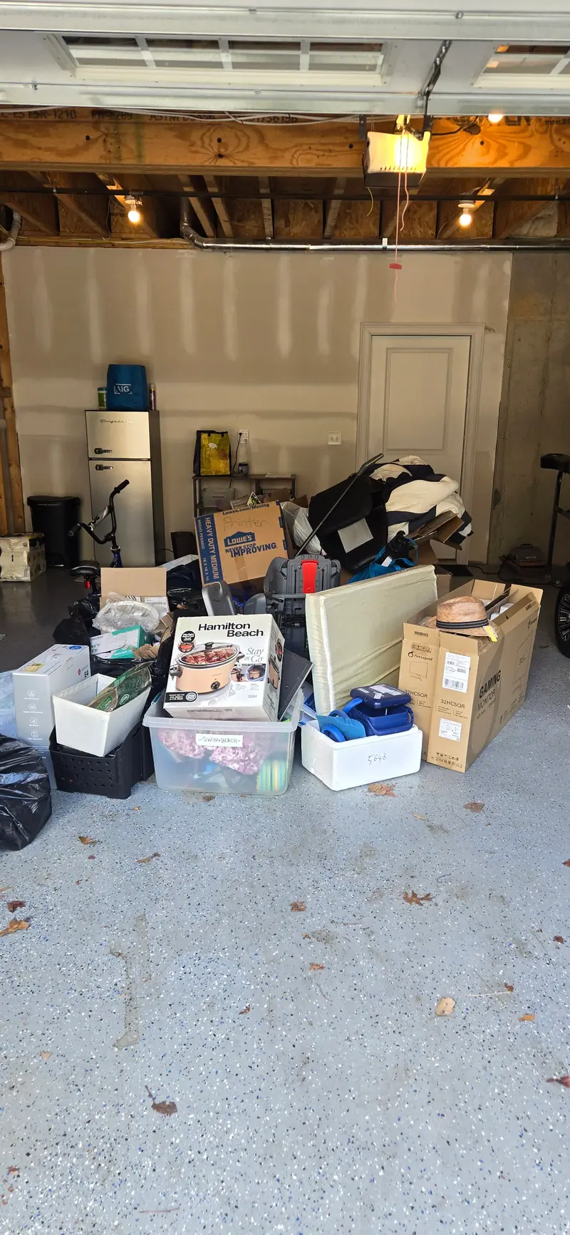 Boxes and bins crowding a garage before the load-out