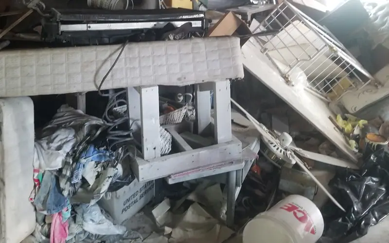 A garage packed wall to wall before cleanout