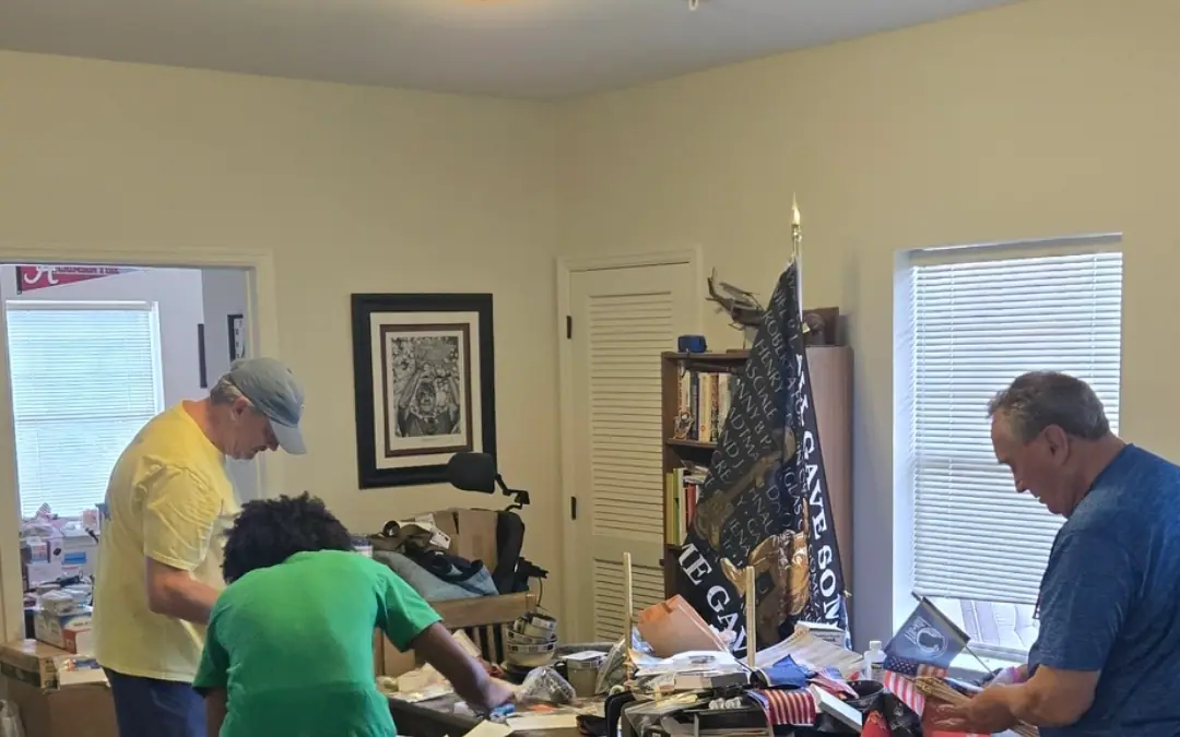 Racoons crew sorting a cluttered kitchen during a whole-house cleanout