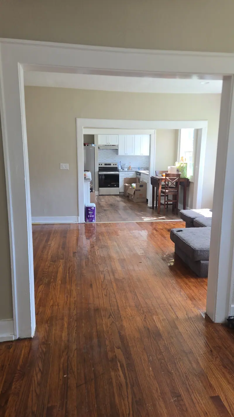 The same living room after the Racoons cleanout, empty hardwood