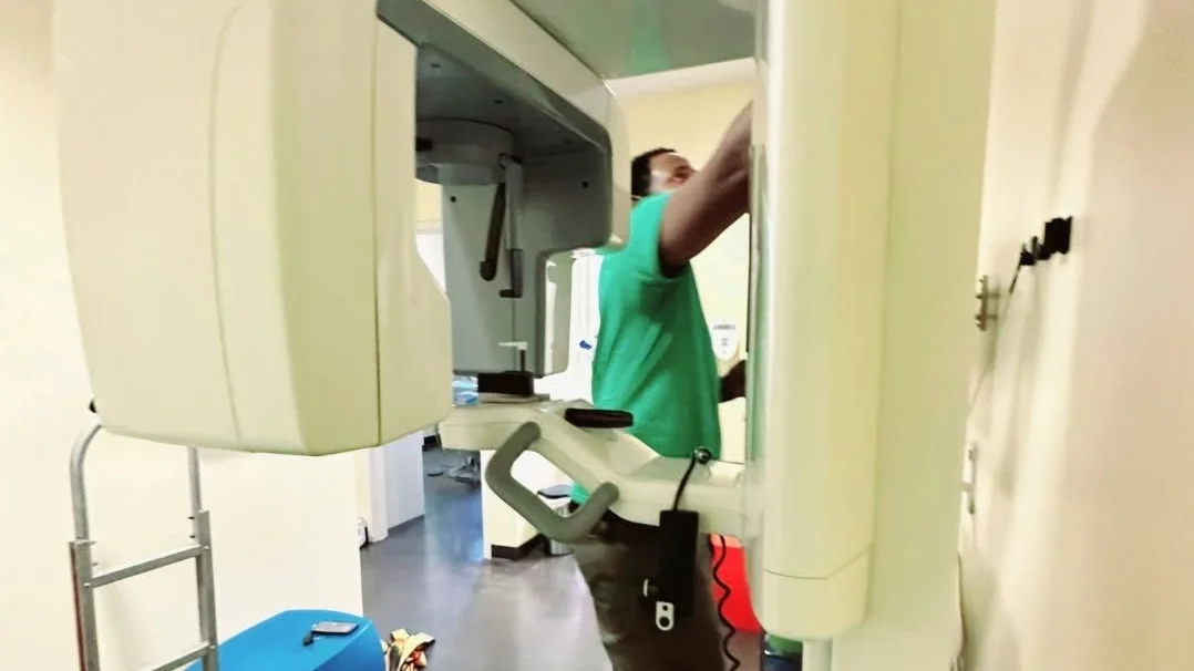 A Racoons crew member taking down a dental panoramic X-ray unit inside a practice