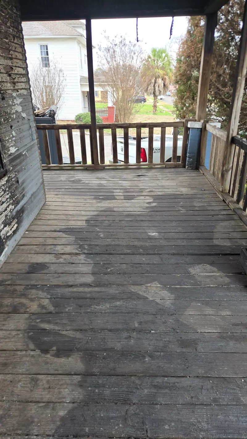 The same porch cleared down to the deck boards
