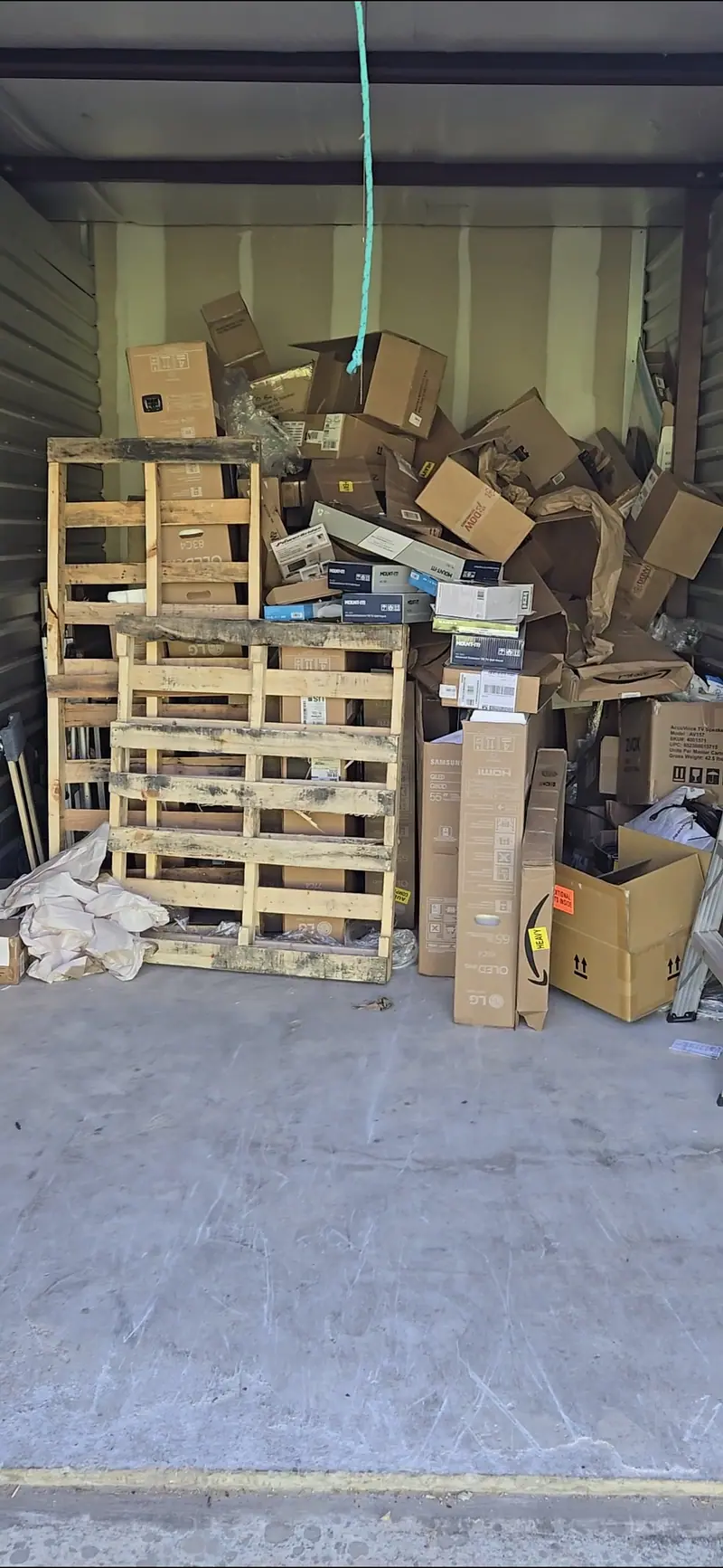 A storage unit stacked with pallets and cardboard
