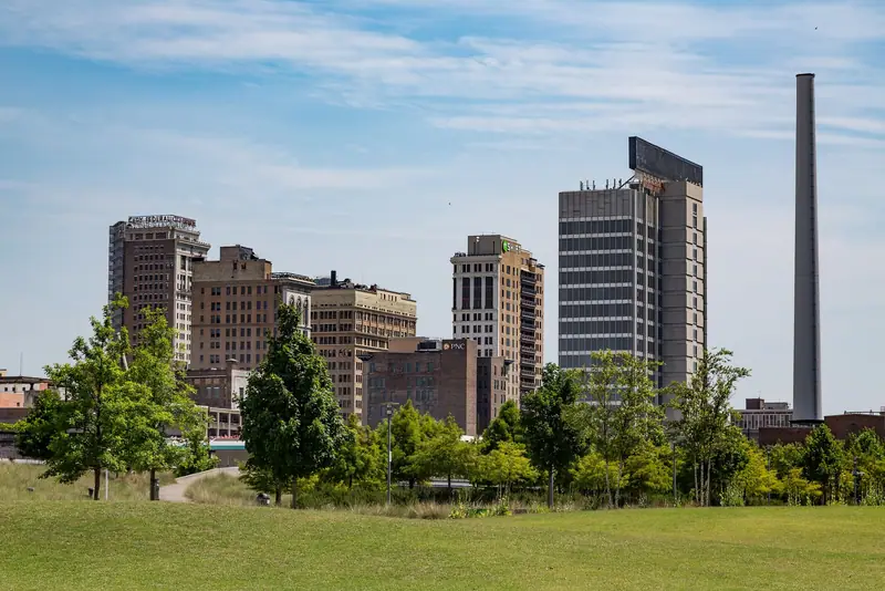 Downtown Birmingham high-rises and a smokestack, seen from Railroad Park