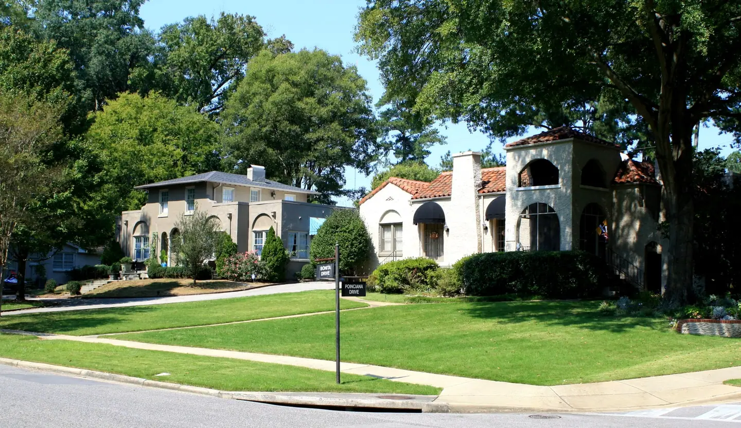 Two stucco houses, one with a red tile roof and arched tower, in Hollywood, Homewood