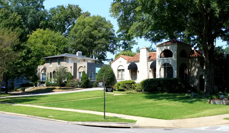 Two stucco houses, one with a red tile roof and arched tower, in Hollywood, Homewood