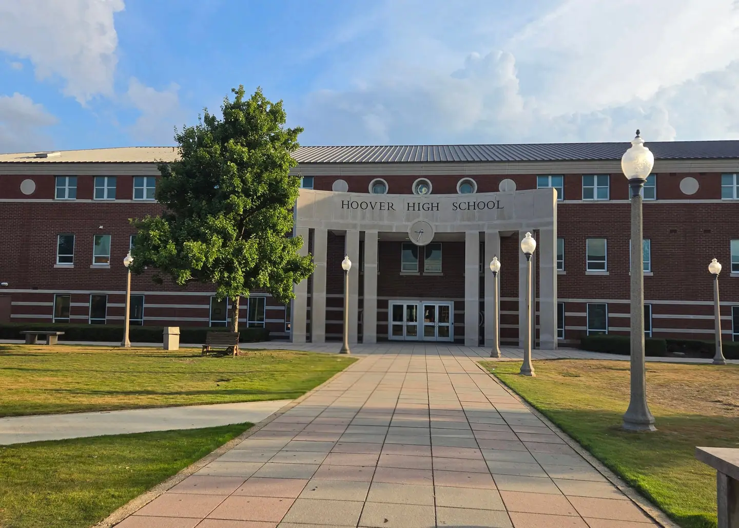 Hoover High School's brick-and-stone entrance, with lamp posts and lawn
