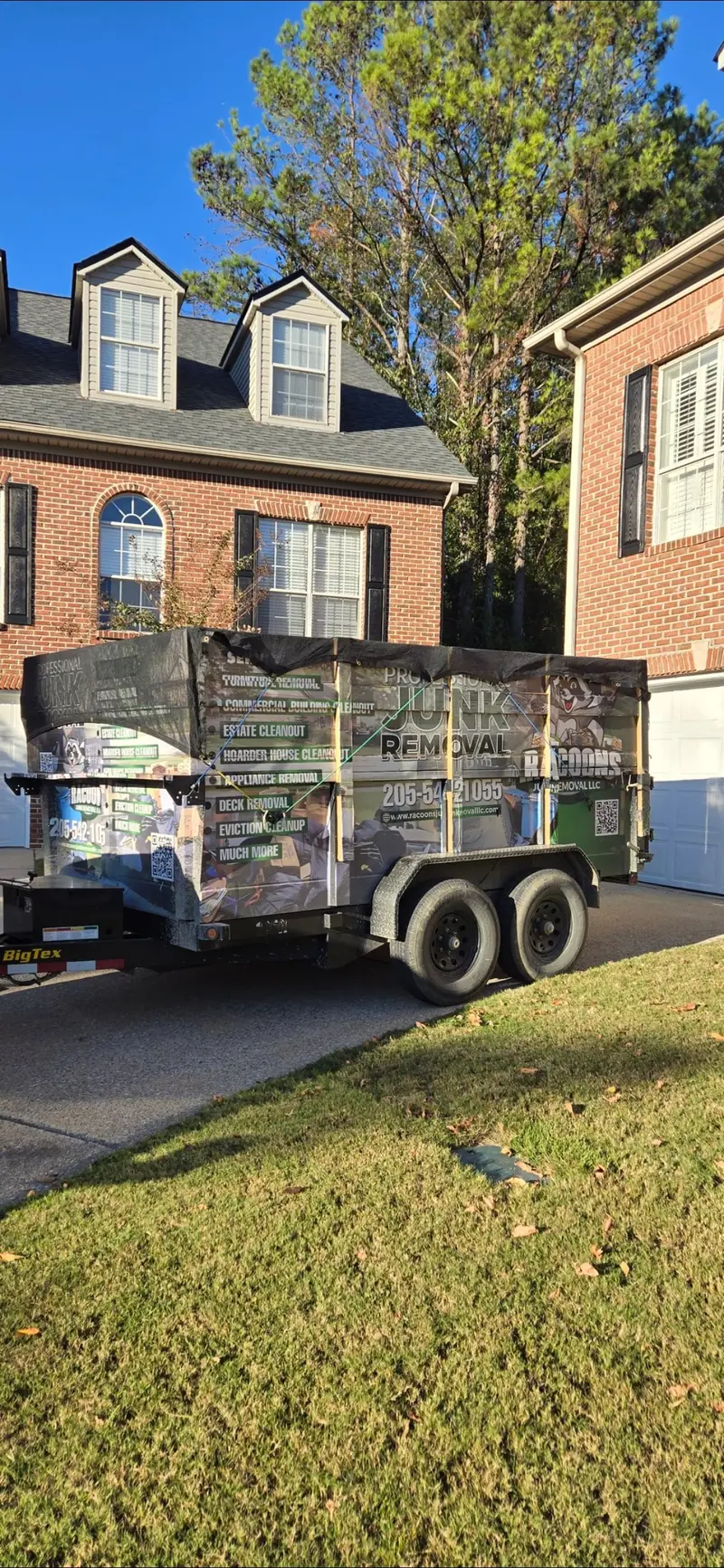 The Racoons dump trailer wrapped with the racoon logo and the services list